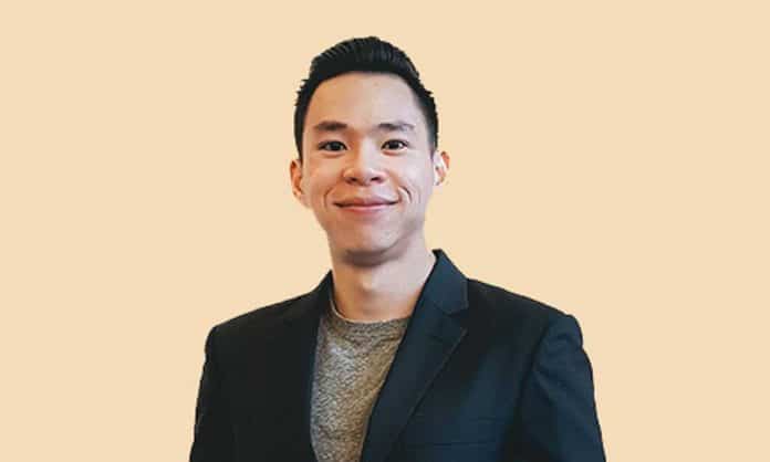 Bust portrait photo of Choong Kar Heng in black suit with tan background