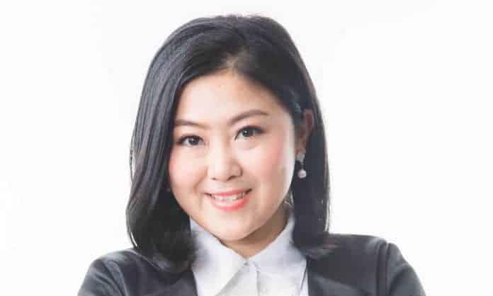 Closeup photo of Datin Jessica Tong in a white dress shirt and black suit with a white background