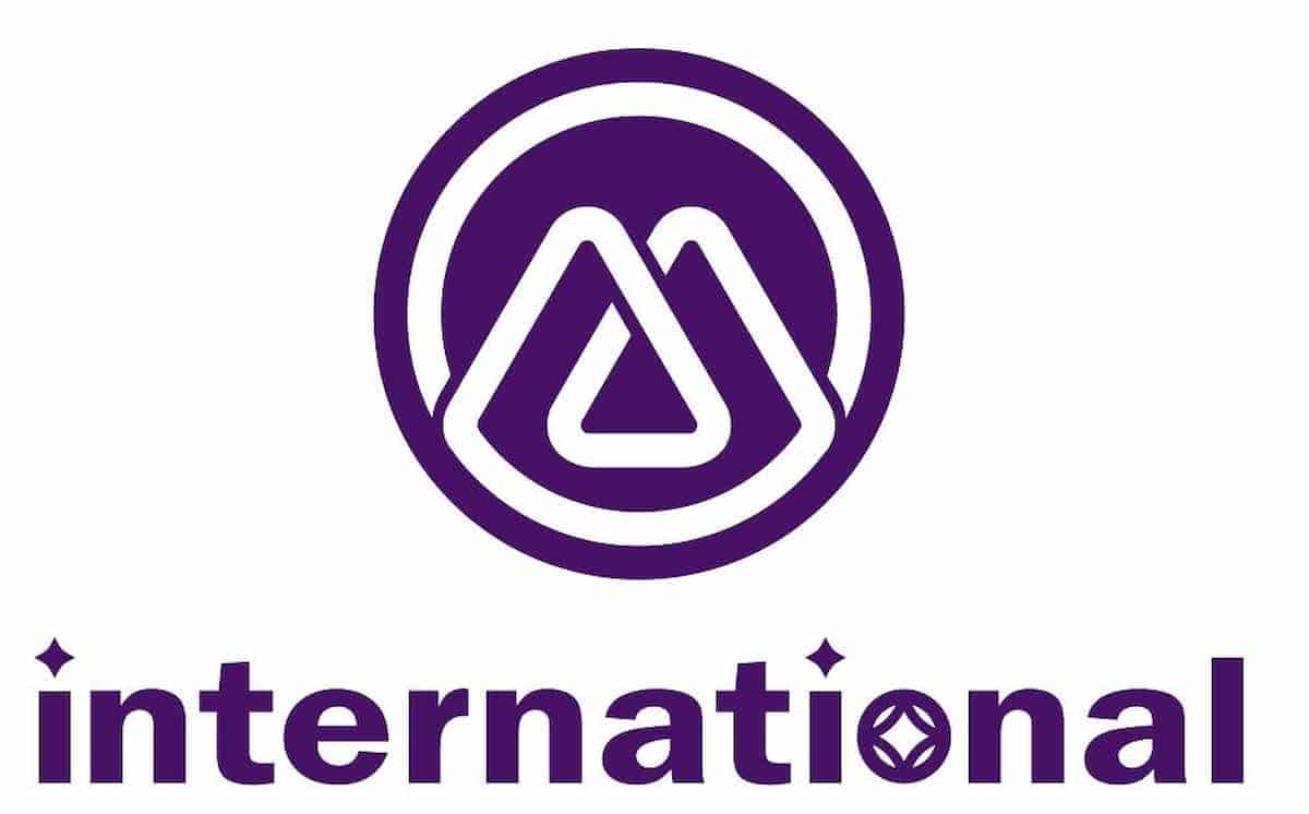 Logo of M International- featuring a purple and white color scheme, with a logo consisting of overlapping rounded triangles forming an 'M' in a circle and 'intenational' lettered in a lowercase sans serif font, with the dots in 'i' and the the inside of 'o' replaced wirh 4-point stars